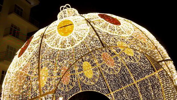 Glowing dome on the outdoor. Clip. Many lightbulbs hanging as garland decorative in festival on dark night sky background, beautiful design of light string photo