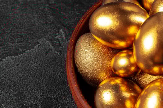 Golden Easter eggs on a black concrete background photo