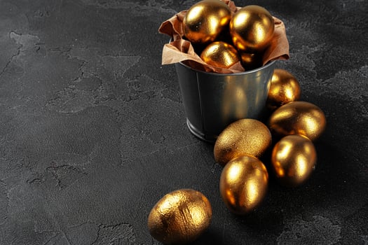 Golden Easter eggs on a black concrete background photo