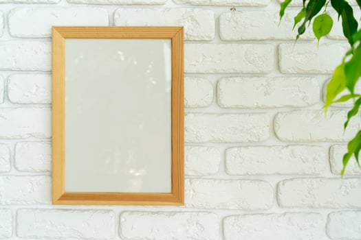 House plant leaves against white brick wall with copy space photo