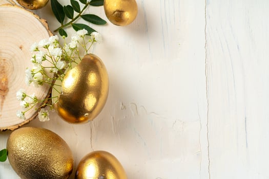 Glossy golden painted eggs with floral branches photo