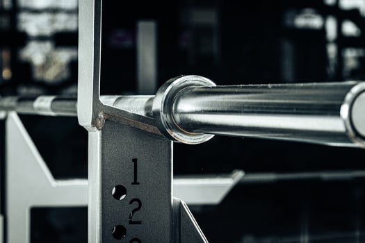 Metal gym weight bar for powerlifting close up photo