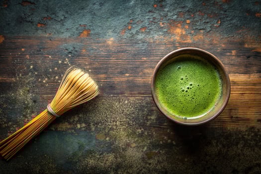 Overhead shot of matcha tea cup on rustic background embodying wabi sabi aesthetics photo