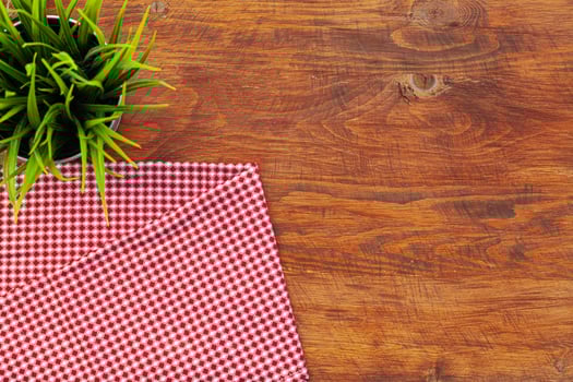 Red checkered napkin or tablecloth on wooden table photo