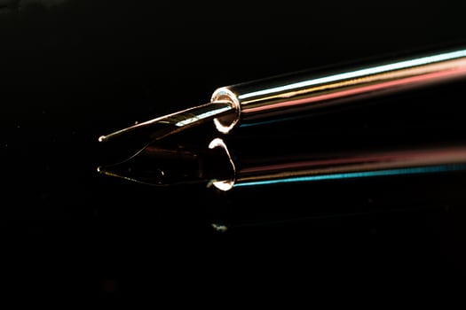 Close up of a pen on black background photo