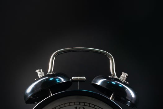 Alarm clock close up on black background photo