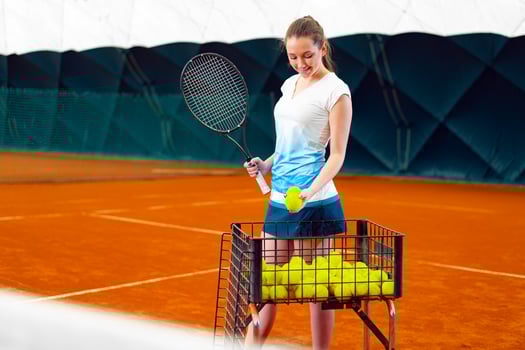 Young woman playing tennis at indoor tennis court photo