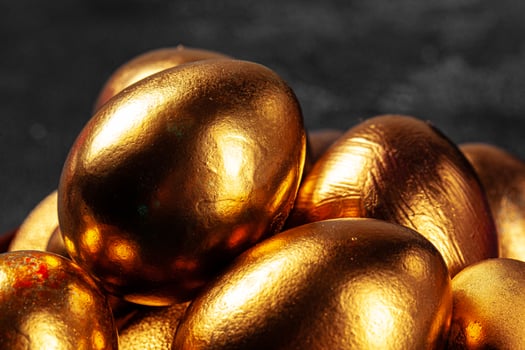 Golden Easter eggs on a black concrete background photo