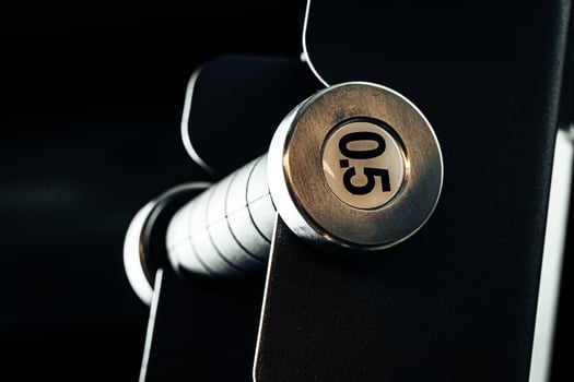 Sports equipment in gym. Dumbbells of different weight close up photo