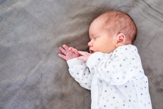 Baby boy sleeping first days of life. Cute little newborn child sleeping peacefully photo