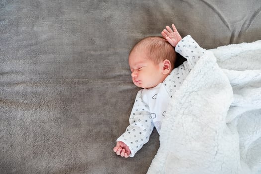 Baby boy sleeping first days of life. Cute little newborn child sleeping peacefully photo