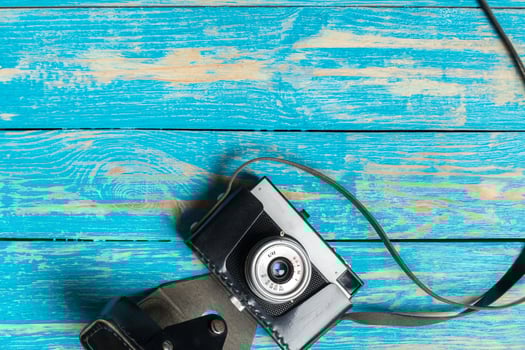 Old retro camera on wooden table background photo