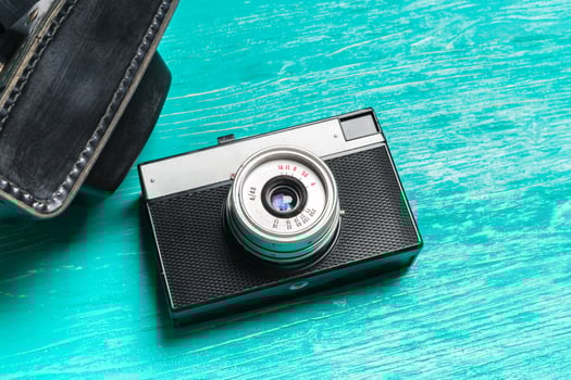 Old retro camera on wooden table background photo