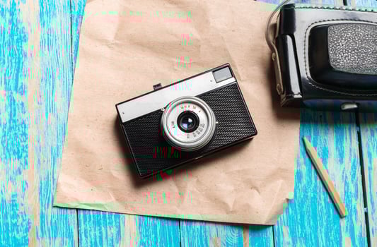 Old retro camera on wooden table background photo