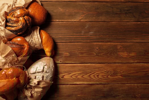 Freshly baked bread on wooden table photo