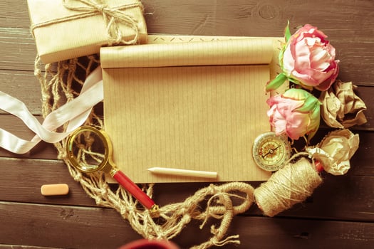 flowers and a notebook on wooden background photo