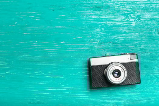 Old retro camera on wooden table background photo