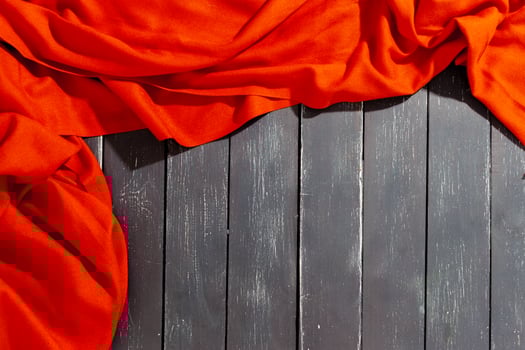 Red scarf over black wood table background photo