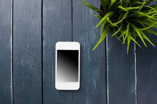 Smart phone on wooden background photo