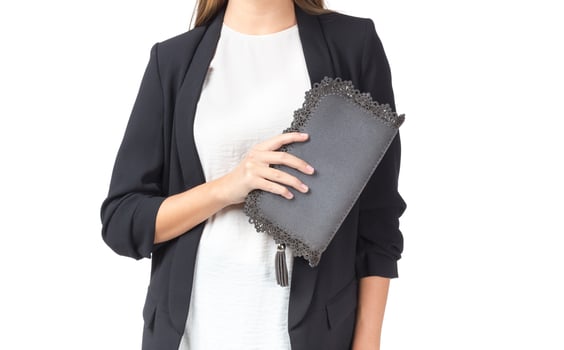 Woman holding a handbag isolated on white background photo