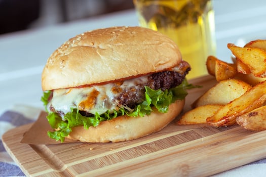 burger and french fries on wooden table photo