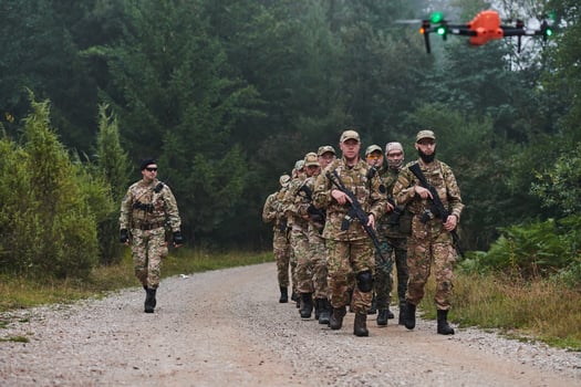 An elite military unit, led by a major, confidently parades through dense forest, showcasing precision, discipline, and readiness for high-risk operations photo