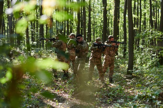 A specialized military antiterrorist unit conducts a covert operation in dense, hazardous woodland, demonstrating precision, discipline, and strategic readiness photo