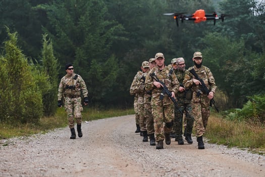An elite military unit, led by a major, confidently parades through dense forest, showcasing precision, discipline, and readiness for high-risk operations photo