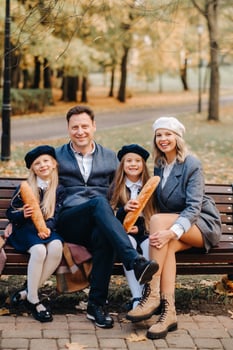 A large family is sitting on a bench in an autumn park. Happy people in the autumn park photo