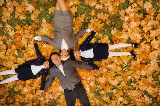 A large family holding hands are lying in an autumn park .Happy people in the autumn park photo