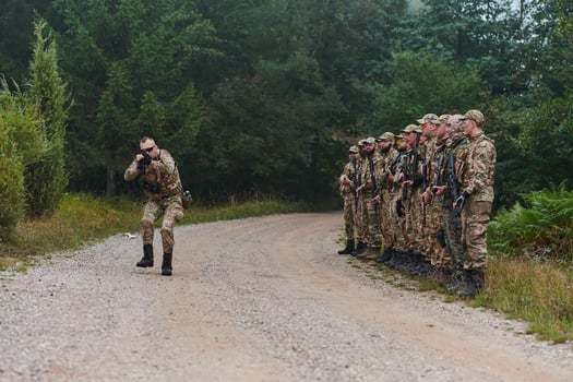A major imparts precise military instructions to his elite unit, embodying strategic leadership as they gather for a briefing on tactical maneuvers and disciplined coordination photo
