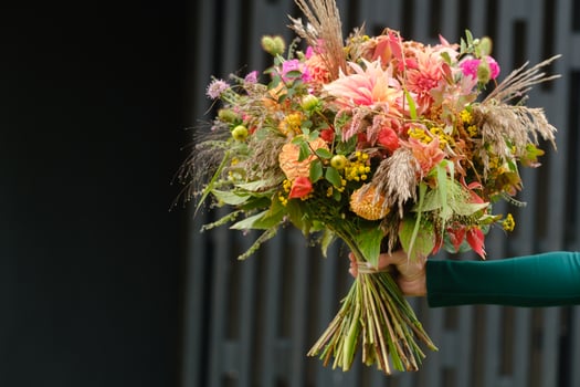 A large bouquet of mixed flowers in the hands of a woman. The work of a florist in a flower shop photo