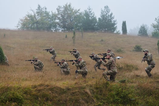 A disciplined and specialized military unit, donned in camouflage, strategically patrolling and maintaining control in a high-stakes environment, showcasing their precision, unity, and readiness for photo