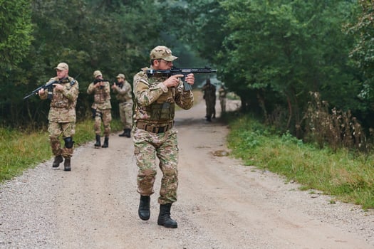 A disciplined and specialized military unit, donned in camouflage, strategically patrolling and maintaining control in a high-stakes environment, showcasing their precision, unity, and readiness for photo