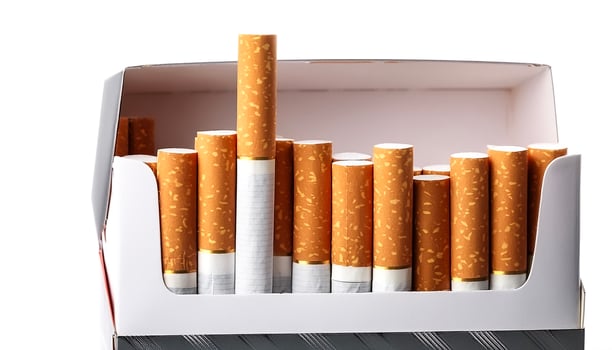 Open pack of cigarettes on a white background photo