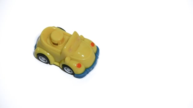 Plastic children's toys on a white background. small white car. Plastic children's toys. Children's toy. photo