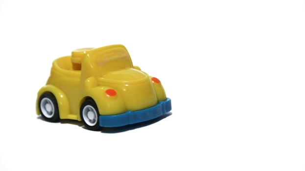 Plastic children's toys on a white background. small white car. Plastic children's toys. Children's toy. photo