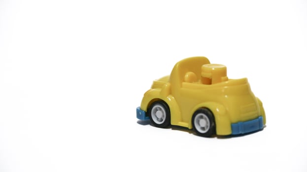 Plastic children's toys on a white background. small white car. Plastic children's toys. Children's toy. photo