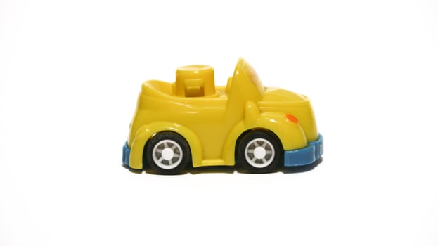 Plastic children's toys on a white background. small white car. Plastic children's toys. Children's toy. photo