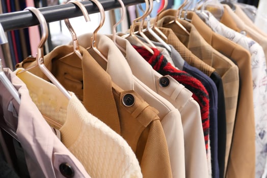 A Stylish Clothing Rack Displaying a Variety of Jackets and Coats for Fashion Enthusiasts photo