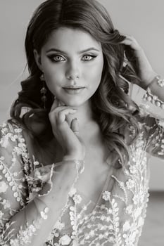 Close-up portrait of a luxurious bride in a wedding dress in the morning in her interior photo