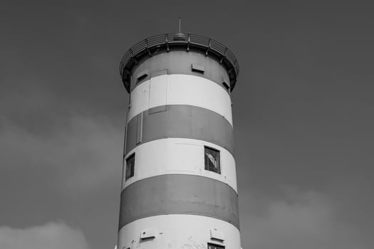 A black and white photo of a lighthouse