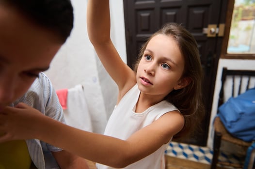 Young girl reaching for something with curiosity indoors photo