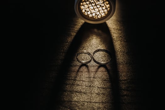 Close-up of two gold wedding rings on a black background photo