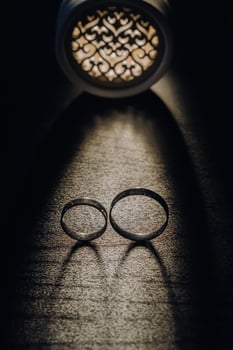 Close-up of two gold wedding rings on a black background photo