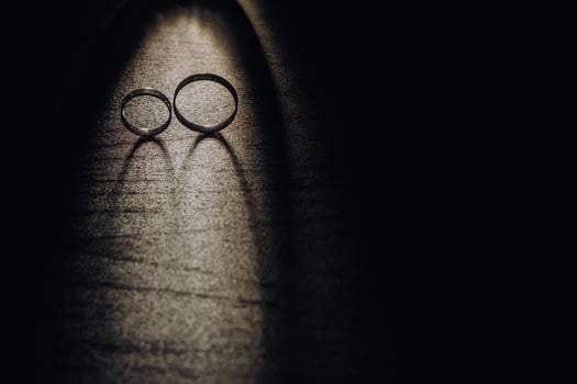 Close-up of two gold wedding rings on a black background photo