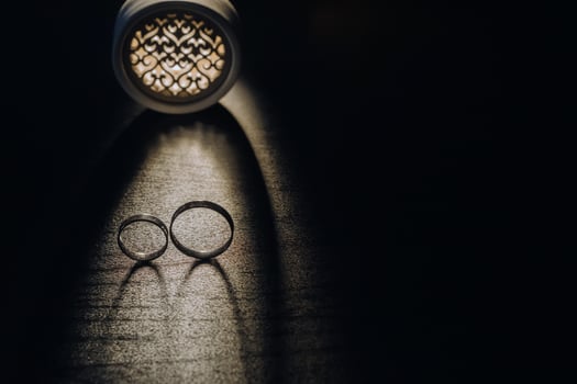Close-up of two gold wedding rings on a black background photo