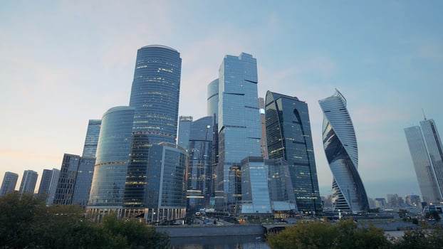 A developing business district in Moscow on Presnenskaya Embankment.Action. Large towers -office buildings with huge transparent windows on a background of grass photo