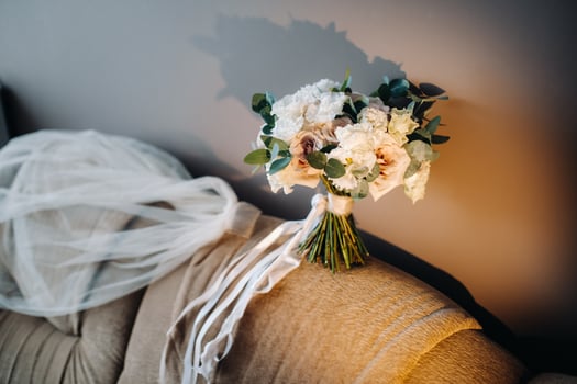 wedding bouquet with roses on a chair and boutonniere.The decor at the wedding photo