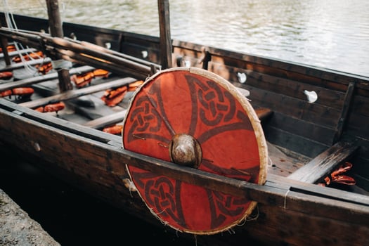 An antique Viking ship on the river. Old boat photo